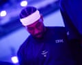 Kawhi Leonard, wearing a white headband, looks down during the national anthem