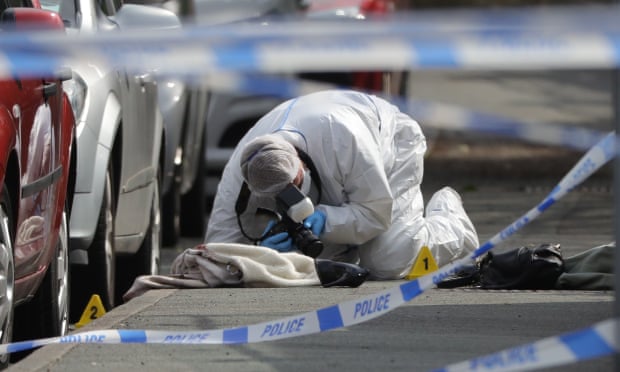 Forensic police photograph the crime scene in Birstall.