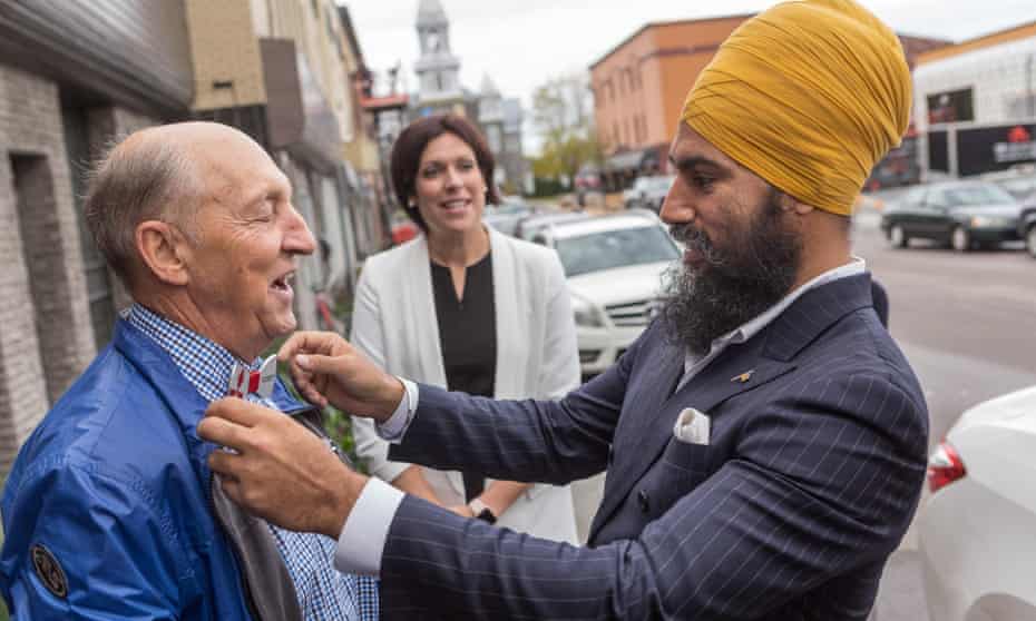 NDP leader Jagmeet Singh talks with a passerby as he visits Alma in the riding of Lac St-Jean on October 10, 2017.