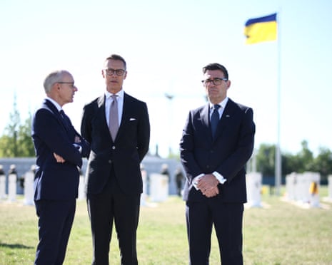 Luxembourg's prime minister Luc Frieden, Finland's president Alexander Stubb and Britain's prime minister Andy Burnham take part in a wreath-laying ceremony at at Ukraine's national military memorial cemetery in Hatne, southwest of Kyiv.