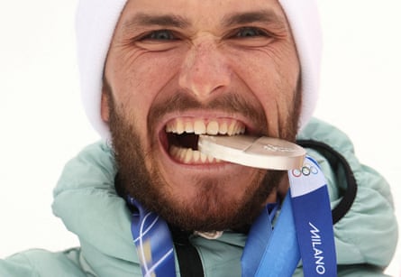 The Russian Nikita Filippov bites his silver medal at in the ski mountaineering – men’s sprint medal ceremony at Milano Cortina 2026
