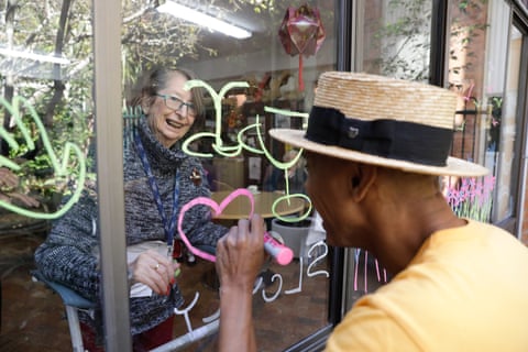 Resident Laurel Moore and musician and actor Benhur Helwend creating window art together at the Whiddon aged care home in Sydney’s north shore. 