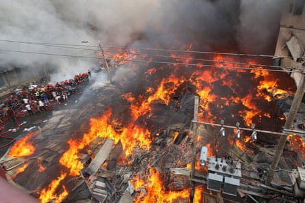 Firefighters try to extinguish a fire that broke out in a clothing market in Dhaka early on Tuesday.