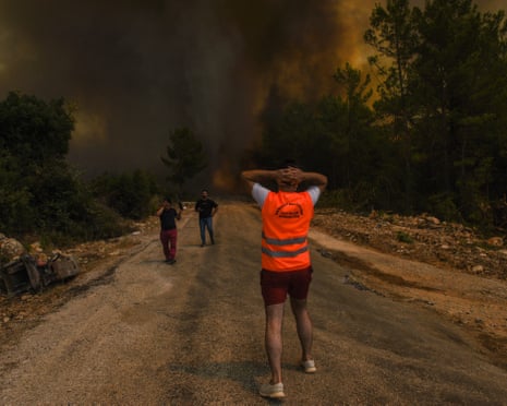 People running away from the fire-devastated Sirtkoy village, near Manavgat, Antalya, Turkey.