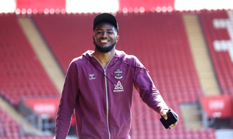 Southampton defender Ainsley Maitland-Niles beams for the cameras as he rocks up for work this afternoon.