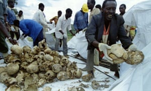 Rwandans place the skulls of several hundred Tutsi civilians into bags after a memorial for approximately 12,000 Tutsi massacred by Hutu militia in and around the western town of Kaduha.