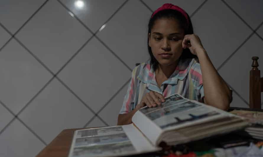 Jennifer Oliveira dos Santos, a filha de 28 anos de Lenilda dos Santos, olha álbuns de fotos com fotos da mãe.