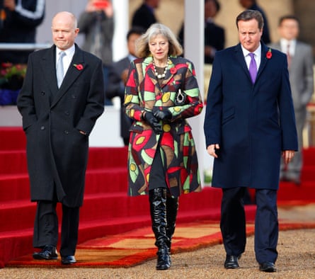 Theresa May pulls of some over-the-knee boots at a public occasion.