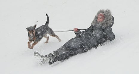 A woman and her dog enjoy the snow near Dublin