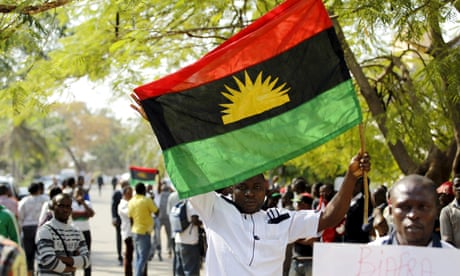 A supporter of the Indigenous People of Biafra (Ipob) holds a Biafra flag at a rally in Abuja