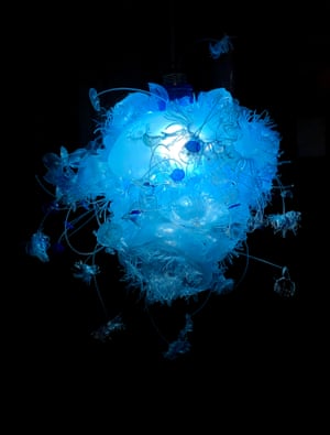 Gulnur Ozdaglar, The Last Reef. This translucent sculpture, suspended from the ceiling, gives viewers a sense of looking up at a complex aquatic organism from underwater. The artist upcycles plastic bottles by applying heat, drilling, cutting and shredding, to evoke the appendages and diaphanous body structures of various forms of sea life.