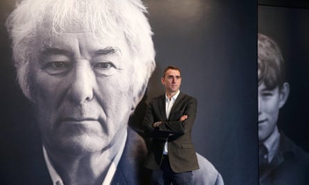 HomePlace manager Brian McCormick, Heaney’s nephew, in front of the poet’s photo at the entrance to the centre.