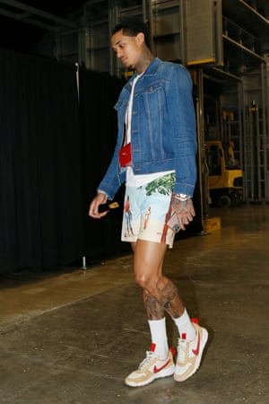 Small holdings: the tiny handbags that became a big thing | Fashion Jordan Clarkson in shorts, trainers and a denim jacket with a tiny red bag around his neck, walking through an airport