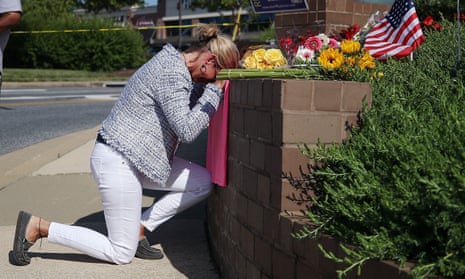 Woman kneeling down at a memorial near the Capital Gazette in Annapolis, Maryland