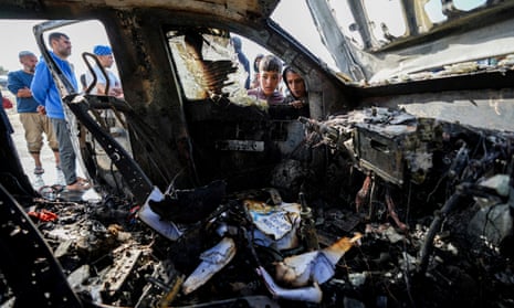 People inspect the site where World Central Kitchen workers were killed in Deir al-Balah, Gaza Strip.