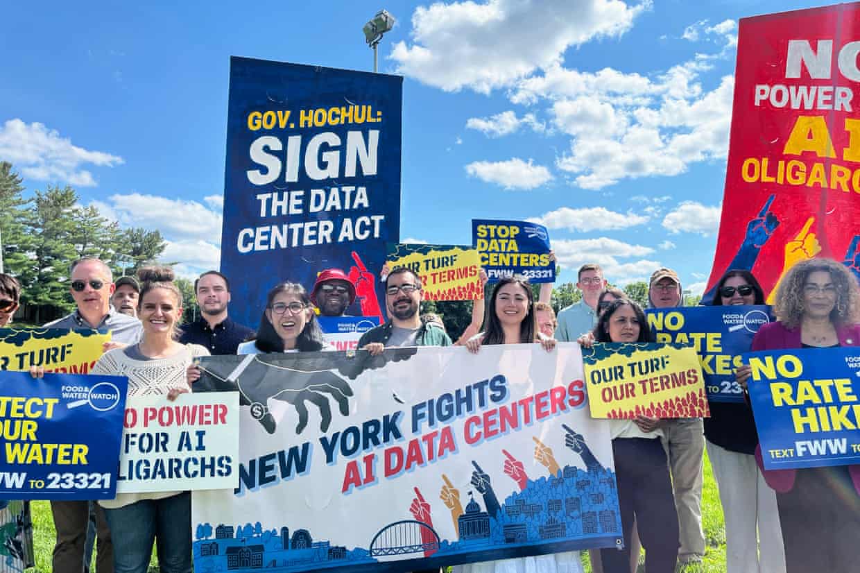 people hold signs against data centers