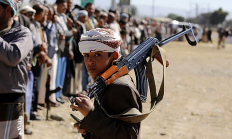 A child supporter of Houthi rebels carries a weapon during a gathering to show support in Sana’a, Yemen