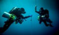 Underwater view of two technical divers using rebreathers device to locate shipwreck, Lombok, Indonesia<br>GettyImages-585283665