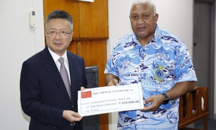 Chinese Ambassador to Fiji Qian Bo hands over FJ$420,000 (about US$200,000) to Fijian prime minister Frank Bainimarama, in December 2020, to support rebuilding after tropical cyclone Yasa.
