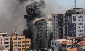 Smoke rises as al-Jalaa tower collapses.