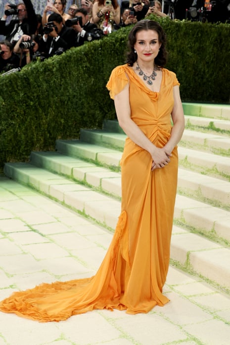 woman in yellow dress smiles