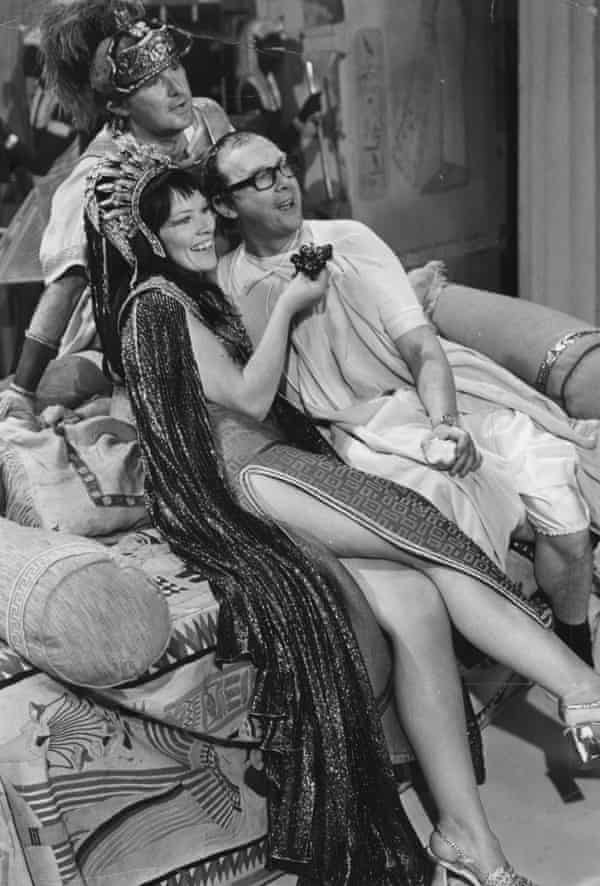 Jackson dressed in Cleopatra outfit with thigh-high slit, holding a bunch of grapes for Eric Morecambe