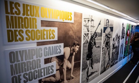 wall with pictures of athletes and exhibition name the Olympic Games, a Mirror of Society exhibition in French and English