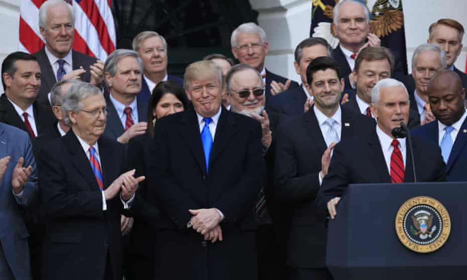 Republican lawmakers celebrate the passage of their tax bill at the White House with Donald Trump and Mike Pence on 20 December 2017.