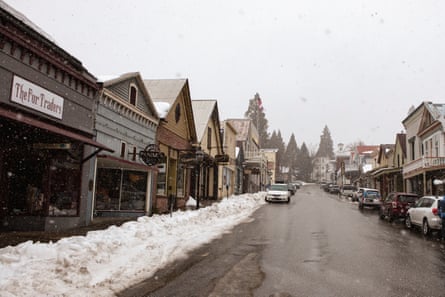Shops line a snow-strewn street.