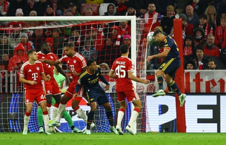 Arsenal’s Bruno Guimaraes leaps to head the ball above Bayern Munich defenders near the goal
