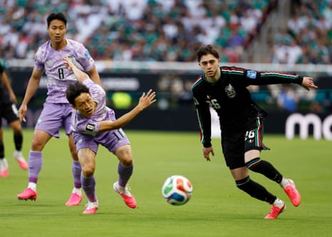 Brian Gutierrez escapes the attention of South Korea's midfielder Lee Jae-sung.