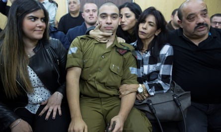 Elor Azaria in court, surrounded by his family.