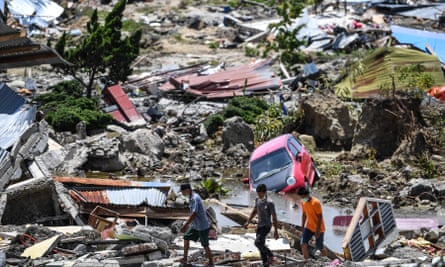 Residents walk through debris in Perumnas Balaroa village in Palu, Indonesia’s Central Sulawesi on 2 October 2018.