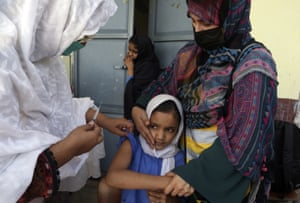 Peshawar, Pakistan: A schoolgirl receives a typhoid vaccine. According to the health department, all children from nine months and 15 years will receive the jab in the first phase of a vaccination campaign