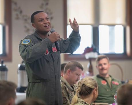 a man in military uniform speaks into a microphone