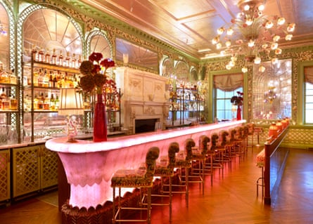 Bright pink lit-up bar with lots of gold decor around it