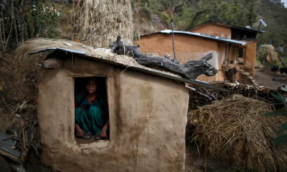 A teenage girl sits in a shed in the hills of Legudsen village in western Nepal’s Achham district