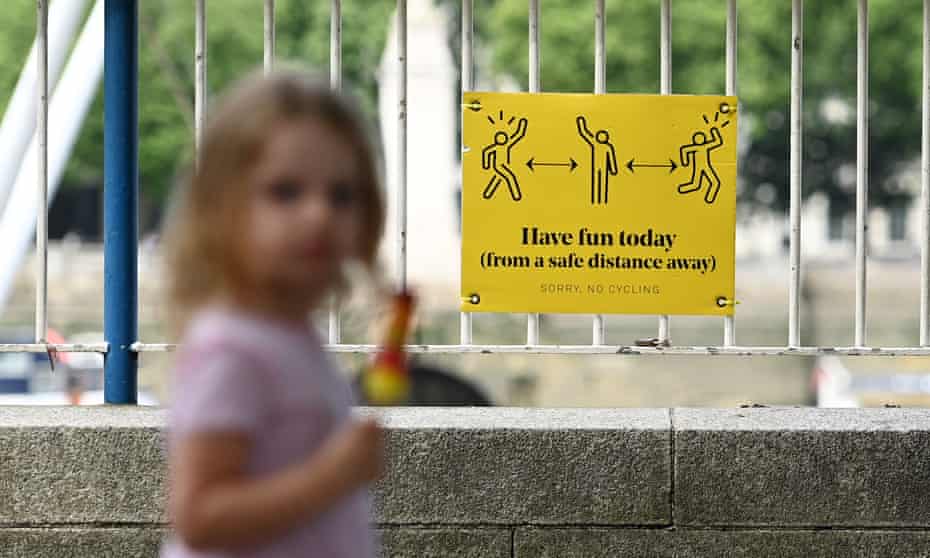 A child passes a social distancing sign along the Southbank in London, Britain, 15 June 2021.