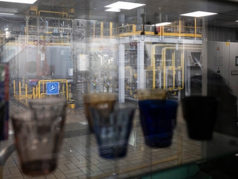Glasses in front of window into factory.