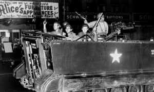 Soldiers in an armoured personnel carrier patrol the streets of Newark during the riots riots.