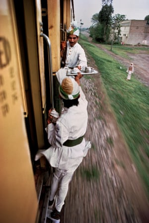 Breakfast Tea being passed between cars on the railway between Peshawar and Lahore, Pakistan, 1983