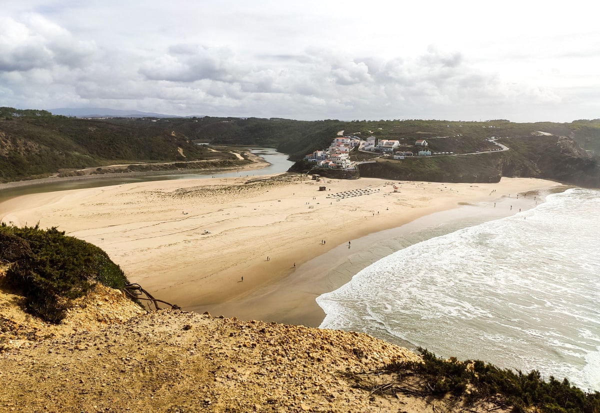 A sandy cove on the Fisherman’s Trail in Portugal, seen from high on a cliff path.