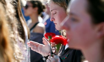 People hold flowers and mourn death of nursing student in Georgia