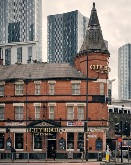 A traditional Manchester pub overlooked by modern towers.