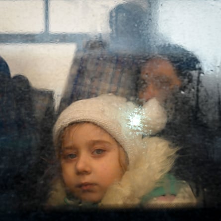 A girl fleeing the conflict in Ukraine looks on from inside of a bus heading to the Moldovan capital Chisinau, after crossing the Moldova-Ukraine border checkpoint near the town of Palanca, on March 2