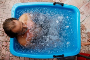 Dubai. A man takes part in a session of ice bath therapy, during which 100kg of ice are added to a bucket and the individuals are coached into breathing before entering