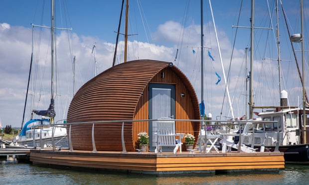 A small wooden ark-inspired hut on a floating platform