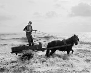 Gordon in the water, Seacoal Beach, Lynemouth,1983 At Lynemouth, for his series Seacoal, Killip photographed men on horse-driven carts reclaiming coal which had been discarded into the sea by a nearby mine