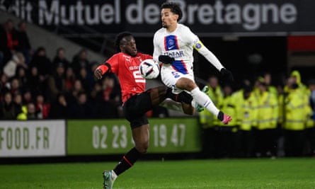 PSG captain Marquinhos (right) takes flight as he fights for the ball with Rennes’ French forward Arnaud Kalimuendo
