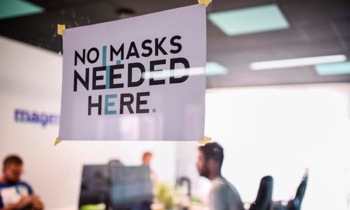 A sign reading ‘No Masks Needed Here’ displayed at a graphic design studio in the town of Gjilan.